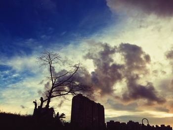 Low angle view of silhouette building against sky