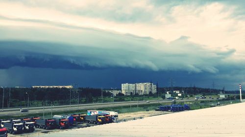 View of harbor against cloudy sky