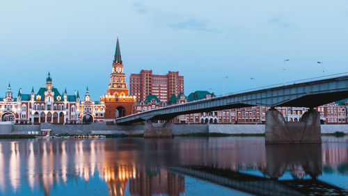 Bridge over river with buildings in background