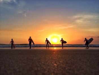 People on beach at sunset