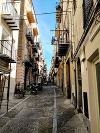 Alley amidst buildings against sky