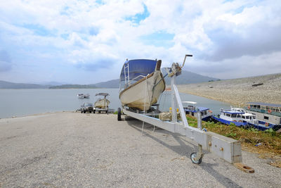 Ship moored on beach against sky