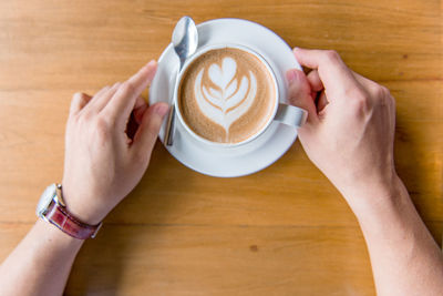 Midsection of woman holding coffee