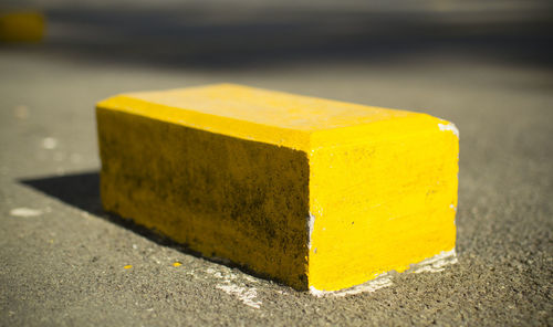 Close-up of yellow block on street