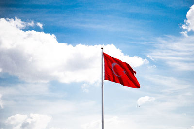 Low angle view of flag on pole against sky