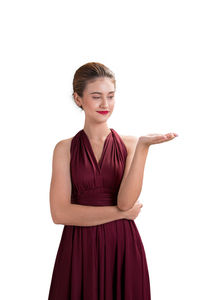 Portrait of young woman against white background