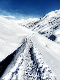 Scenic view of snow covered mountains against sky