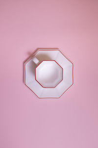 Directly above shot of illuminated lamp against pink background