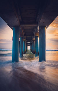 Interior of pier over sea against sky