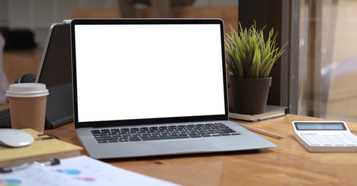 View of laptop and smart phone on table