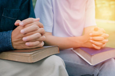 Midsection of man holding book