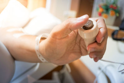 Cropped image of hand holding coffee cup
