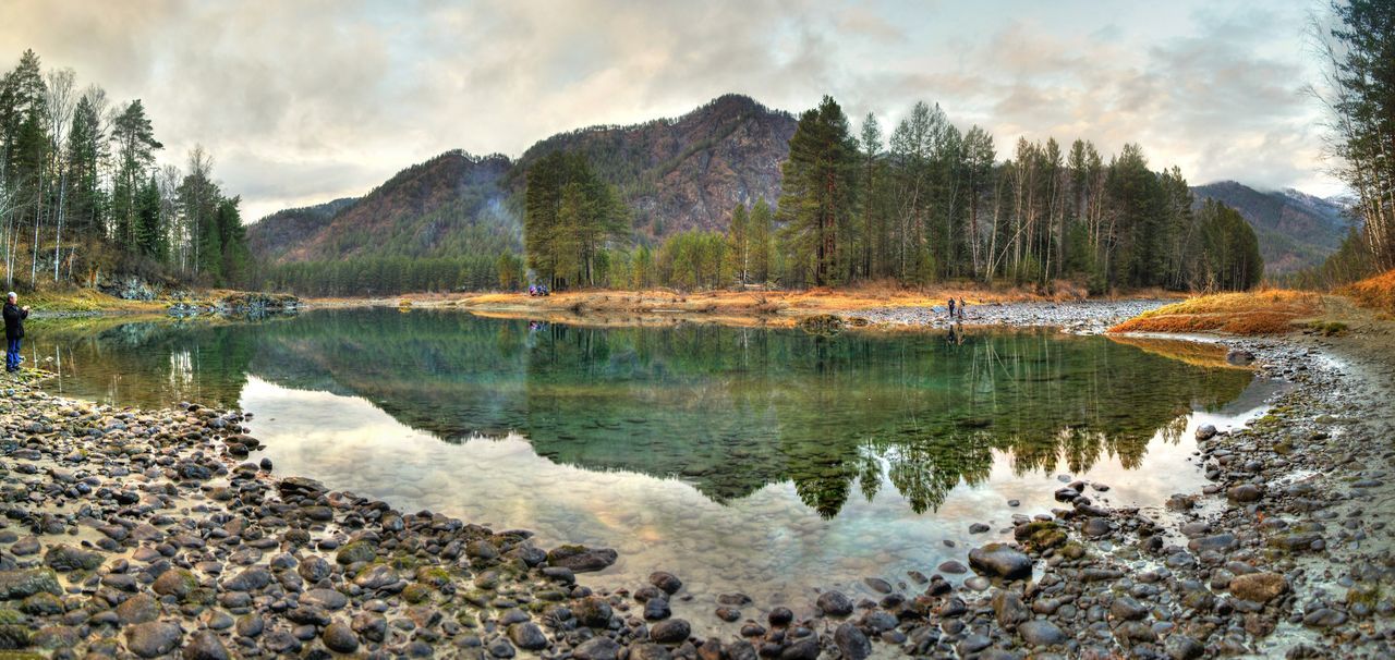 water, tranquil scene, tranquility, sky, scenics, lake, beauty in nature, tree, reflection, nature, cloud - sky, mountain, rock - object, river, non-urban scene, idyllic, cloud, lakeshore, day, cloudy