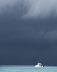 Boat sailing in sea against sky