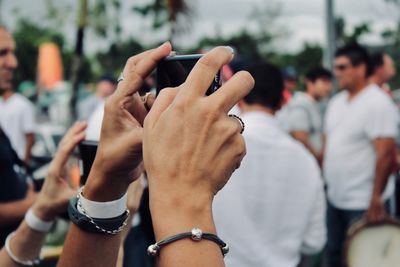 Midsection of woman using mobile phone