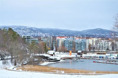 Buildings in city against sky during winter