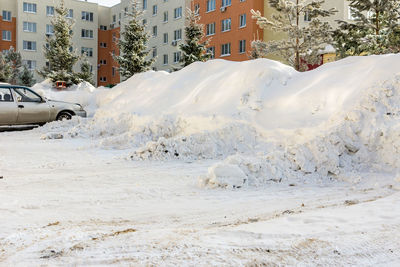 Snow covered houses in city during winter