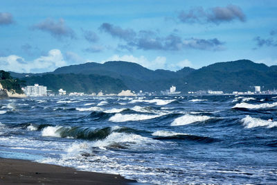 Scenic view of sea with big waves against sky