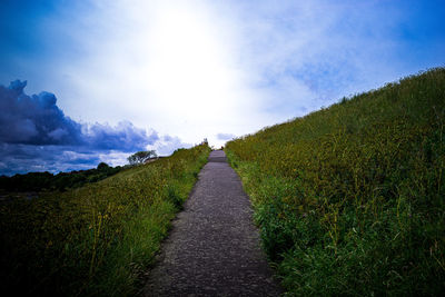 Empty road along countryside landscape