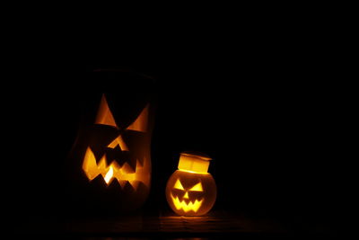 Illuminated pumpkin against black background
