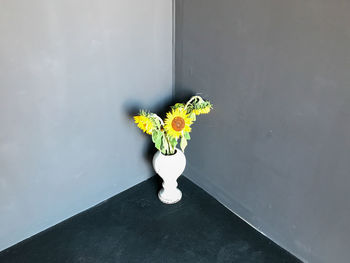 Close-up of flower vase on table against window