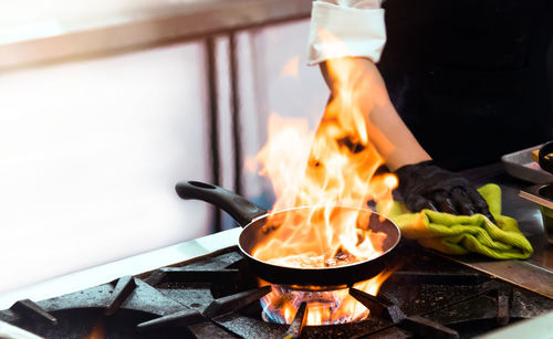 Cropped hand of man preparing food