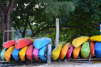 Multi colored umbrellas against trees