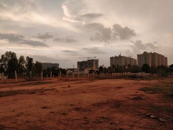 Buildings in city against sky during sunset