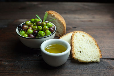 Close-up of olives and bread on table