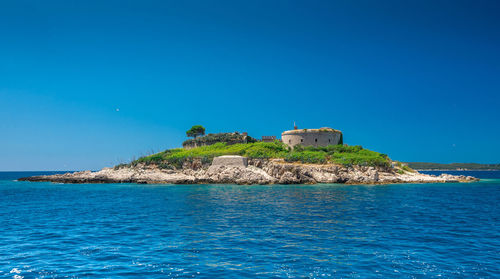Scenic view of sea against clear blue sky