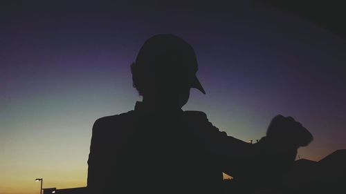 Low angle view of silhouette people against sky