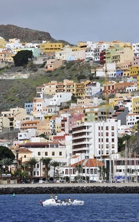 Town by sea against sky in city