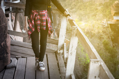 Low section of women walking on footbridge