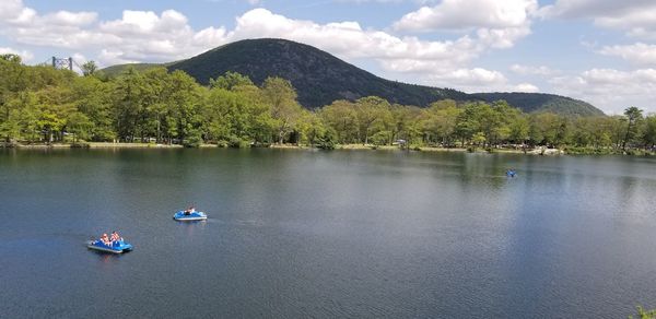 Scenic view of lake and mountains against sky