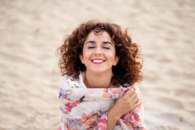 Smiling woman standing on sand