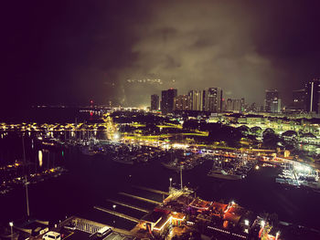 High angle view of illuminated buildings in city at night