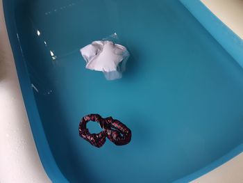 Clothes over still water on inflatable swimming pool