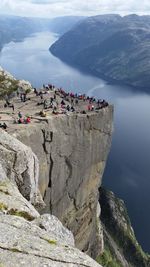 High angle view of people on cliff against sky