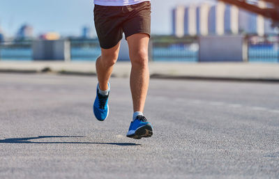 Low section of man running on floor