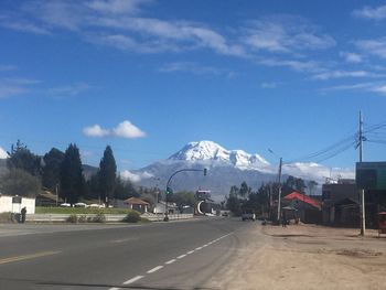 Scenic view of snow covered mountains against cloudy sky