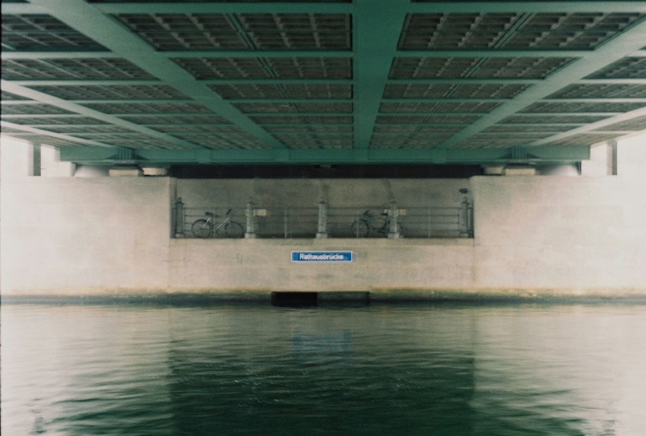 LOW ANGLE VIEW OF BUILDING WITH REFLECTION ON WATER