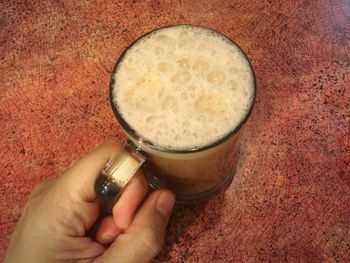 Cropped image of hand holding coffee cup