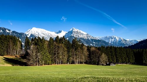 Scenic view of mountains against blue sky