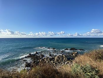 Scenic view of sea against blue sky