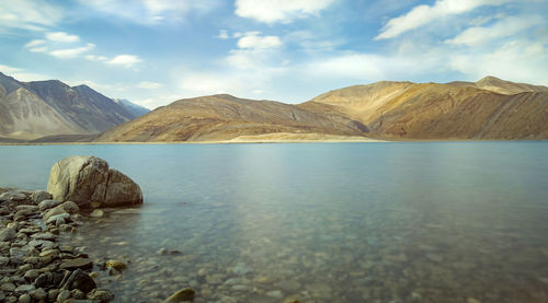 Scenic view of mountains and sea against sky