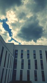 Low angle view of building against cloudy sky