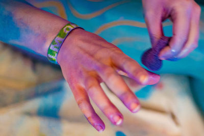 Close-up of woman hand with multi colored hair