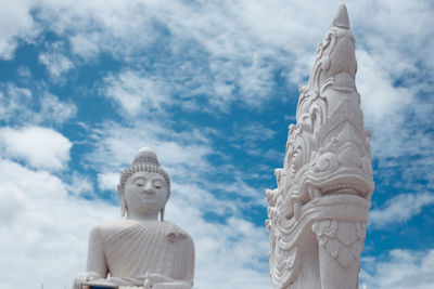 Low angle view of statue against temple against sky