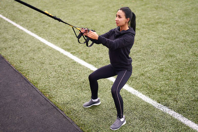 Full length of woman running on grassland