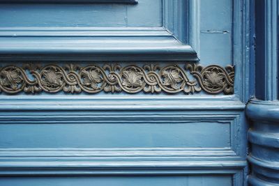 Close-up of text on blue door